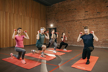 group workout, dumbbells, yoga mat, indoor exercise, strength training, fitness session, group fitness, indoor workout, exercise class, fitness group, strength exercise