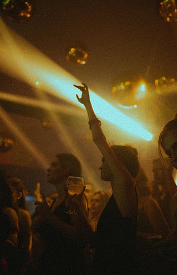 nightclub, people dancing, colorful lights, vibrant scene, lively atmosphere, partying, club, disco balls, nightlife, dance floor, entertainment