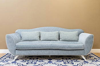 blue sofa, cushions, patterned carpet, modern living space, cozy living room, stylish sofa, blue cushions, living room furniture, contemporary sofa, home decor, interior design