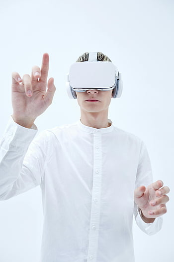 virtual reality, VR headset, man in white, long sleeves, futuristic background, exploring technology, virtual reality technology, person using VR, white background, virtual reality goggles, futuristic technology