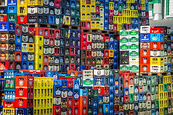 beverage crates, beer crates, stacked crates, warehouse display, vibrant display, various brands, colorful crates, beverage storage, beer storage, warehouse crates, stacked beer crates