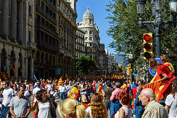 people rallying, Barcelona streets, flags, banners, unity, protest, demonstration, crowd, public event, cityscape, march