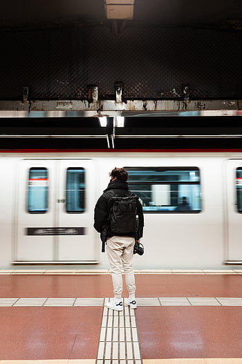 metro platform, unrecognizable man, train, backpack, bustling metro station, urban life, motion, waiting, station, subway, travel