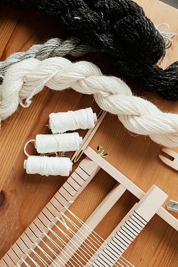 small hand loom, wooden loom, yarn, thread, craft projects, DIY projects, overhead shot, wooden table, weaving, textile art, handmade