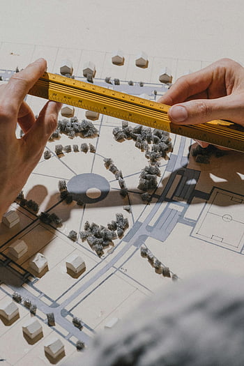 architectural model, close-up, hands, measuring, ruler, natural light, architectural design, model building, scale model, precision, planning