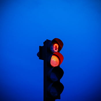 red traffic light, blue sky, twilight sky, stop signal, illuminated light, vibrant blue, traffic signal, evening sky, stop sign, traffic control, red light