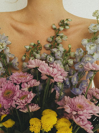 bunch of flowers, woman's chest, beautiful bouquet, chrysanthemums, delphiniums, delicate feminine touch, floral arrangement, pink flowers, yellow flowers, purple flowers, floral composition