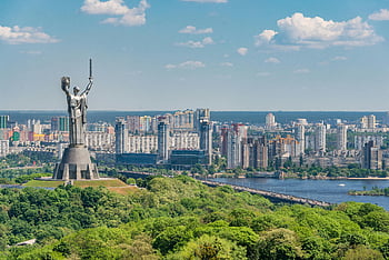 Motherland Monument, green trees, embankment, Kiev, Kyiv city, Dnieper River, sunny day, urban skyline, outdoor scenery, landmark, Ukraine