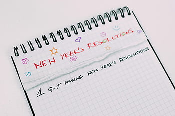New Year's resolutions, notebook page, handwritten text, colorful text, graphing paper, spiral notebook, New Year goals, planning, journal entry, personal goals, motivation
