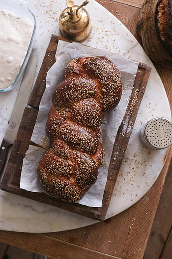 brown bread, wooden tray, braided bread, sesame seeds, freshly baked, breakfast, brunch, sesame bread, wooden cutting board, sesame topped bread, artisan bread
