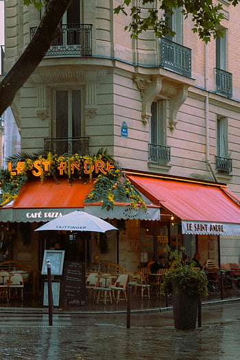 Parisian cafe, Le Saint Andre, rainy day, classic French ambiance, red awning, umbrella, cozy restaurant, outdoor seating, French cuisine, European architecture, city street scene