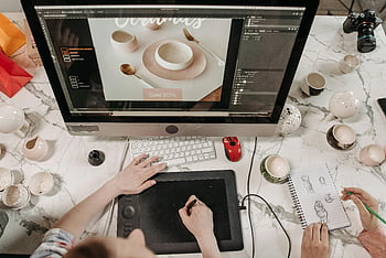 creative workspace, design tools, sketches, teamwork, collaboration, overhead view, computer work, graphic tablet, workspace design, creative collaboration, design sketches