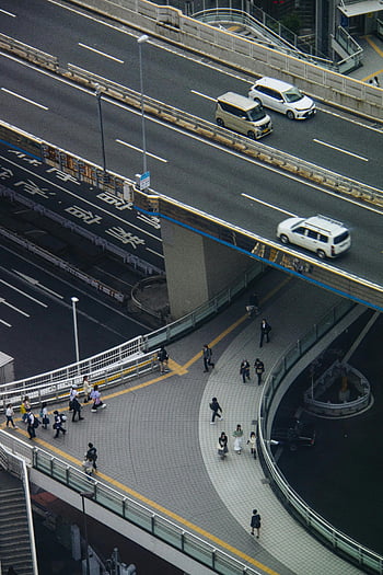 Tokyo, aerial view, busy highway, pedestrian walkway, urban traffic, cityscape, bustling activity, elevated road, modern infrastructure, Japanese city, transportation network
