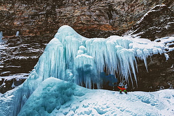 ice climbing, frozen waterfall, winter landscape, icicles, mountain, daring climber, icy embrace, snow, outdoor adventure, extreme sports, nature photography