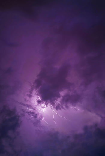lightning strike, dark clouds, nighttime thunderstorm, vivid lightning, dramatic sky, purple clouds, stormy weather, electric flash, atmospheric phenomenon, natural light show, thunderstorm clouds