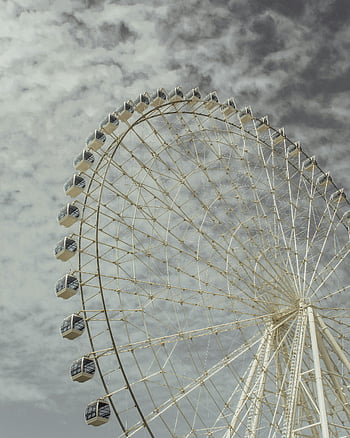 White Giant Ferris Wheel, low angle shot, cloudy sky, adventure, amusement park, outdoor attraction, giant wheel, sky backdrop, low angle view, Ferris wheel, cloudy day
