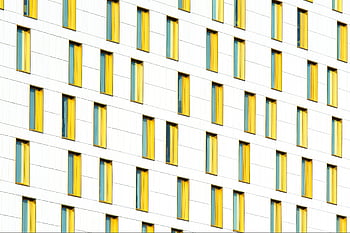Geometric Building Facade, Modern Architecture, Yellow Windows, High Contrast, Architectural Design, Artistic Building, Urban Photography, Minimalist Architecture, Geometric Patterns
