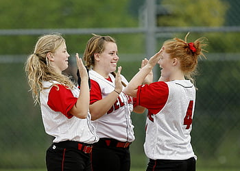 girls, white red jersey, playing hand game, teen girls, softball uniforms, celebrating victory, high-fives, outdoors, sports team, female athletes, softball players