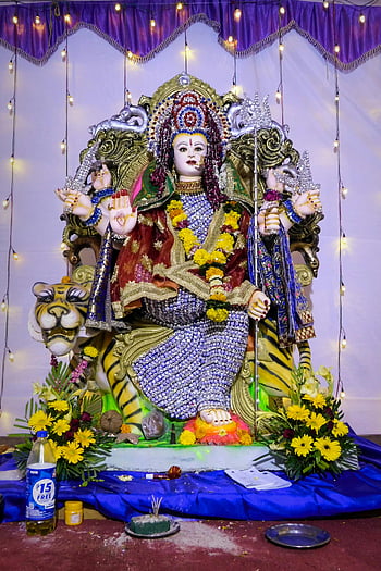 Goddess Durga, Durga Puja, festival of India, vibrant colors, traditional attire, Mumbai, Hinduism, religious celebration, flower decoration, statue, spiritual