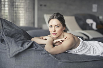 woman covered in towel, lying on bed, relaxation, wellness, Budapest hotel spa, serene moment, spa treatment, relaxation therapy, spa relaxation, wellness retreat, spa bed