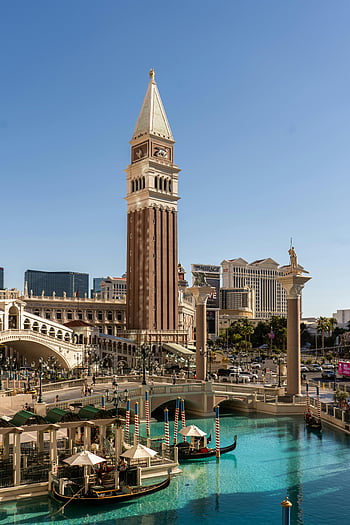 Venice miniature, Las Vegas, sunny day, Venetian Resort, canals, iconic architecture, clear blue sky, gondolas, Rialto Bridge, bell tower, Las Vegas Strip