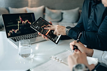 financial data analysis, professionals, office setting, digital tablet, laptop, financial charts, business meeting, data visualization, stock market analysis, office work, technology in finance
