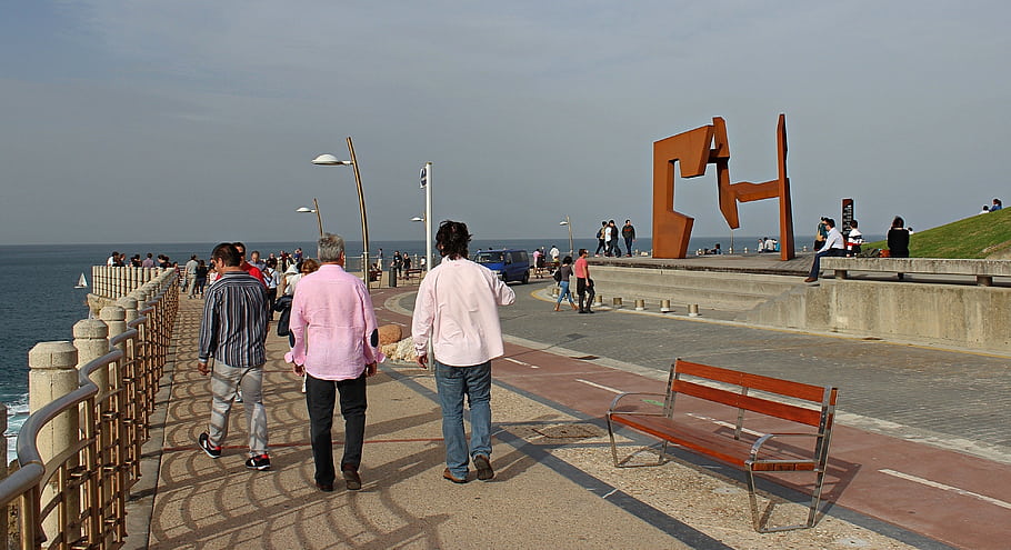 San Sebastián, Guipúzcoa, Spain, Paseo Nuevo, seaside promenade, people walking, bench, modern sculpture, ocean view, street lamps, concrete path