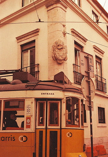 vintage tram, Lisbon, historic street, yellow tram, vintage yellow tram, Lisbon tram, historic Lisbon, street corner, classic tram, Portugal, Carris