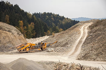 crusher machine, open pit, industrial machinery, forest quarry, landscape, daytime, mining equipment, quarrying, heavy machinery, construction site, natural resources