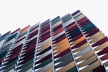 low angle shot, concrete building, multi-colored facade, modern architecture, architectural patterns, dynamic image, building exterior, colorful building, contemporary design, urban architecture, geometric patterns