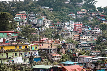 Baguio, Philippines, dense hillside, residential area, colorful buildings, lush greenery, Favela Quarter, urban landscape, hillside community, vibrant houses, tropical setting