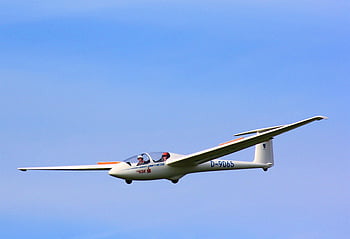 two-seater glider, white D-9065 plane, clear blue sky, two people inside, flying gracefully, aircraft, aviation, gliding, outdoor, sky, flight