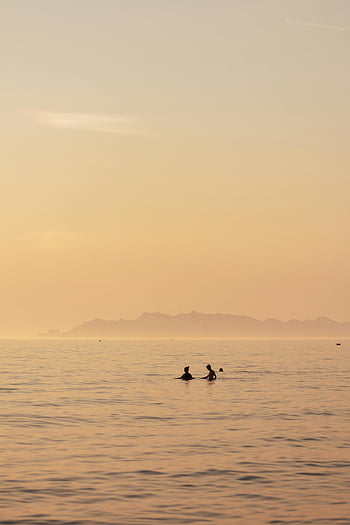 sunset swimming, Durrës Albania, island view, body of water, gloomy sky, people swimming, sunset photo, sea landscape, coastal scene, evening swim, tranquil waters