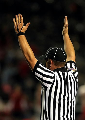 referee, raising hands, goal signal, touchdown signal, sports official, match signal, referee gesture, sports referee, game signal, sports action, referee uniform