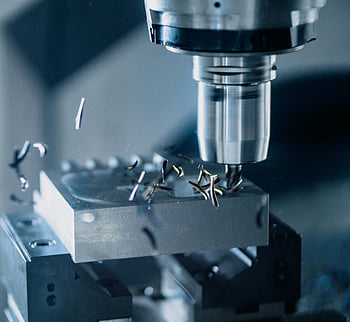 CNC milling machine, metal tool, precise manufacturing, close-up photo, metal machining, industrial equipment, metalworking process, machine tool, metal fabrication, precision cutting, metal shavings
