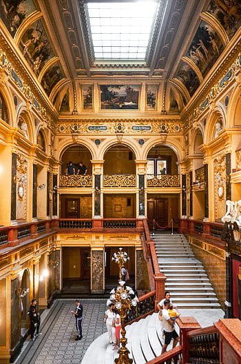 historic palace, arched passages, ornamental elements, grand theater, classic architecture, decorative elements, spacious design, Lviv, ornate interior, marble steps, chandelier