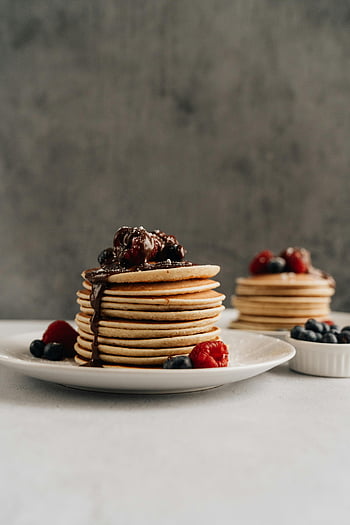stacked pancakes, ceramic plate, berries, chocolate syrup, perfect breakfast, mouthwatering pancakes, breakfast food, pancake stack, breakfast plate, berry pancakes, chocolate pancakes