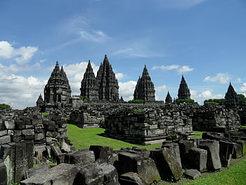 Prambanan Temple, Java, Indonesia, ancient architecture, stone architecture, clear blue sky, cloudy sky, gray concrete buildings, historical site, travel destination, cultural heritage
