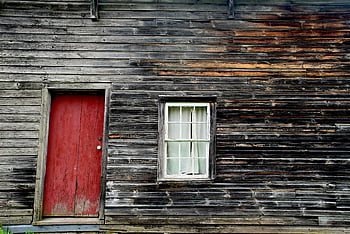 closed red wooden door, weathered wooden cabin, rustic red door, vintage charm, wooden cabin exterior, red door, rustic window, vintage cabin, weathered wood, rustic charm, red wooden door