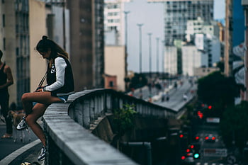 Donna seduta sul ponte, rail bridge, paesaggio urbano, Scena diurna, contesto urbano, posa casual, vista della città, vista del ponte, donna sul ponte, vita di città, stile di vita urbano