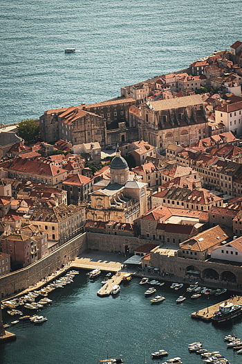 Dubrovnik, Croatia, aerial view, coastal cityscape, harbor, cathedral, stunning photo, city charm, old town, Adriatic coast, Mediterranean architecture
