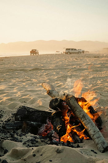 beach bonfire, sunset, California coast, sandy beach, warm bonfire, coastal evening, beach fire, sunset beach, bonfire atmosphere, beach sunset, coastal bonfire