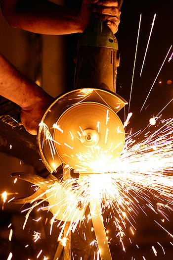 angle grinder, flashing sparks, industrial power tool, vibrant sparks, tool dynamics, metal cutting, sparks flying, power tool action, angle grinder sparks, metalworking tool, industrial tool