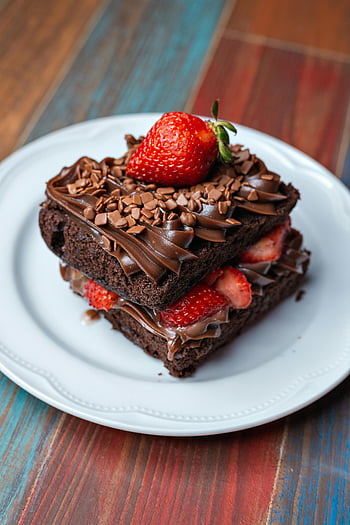 brownies, chocolate brownie, fresh strawberries, chocolate chips, mouthwatering dessert, indulgent treat, chocolate topping, dessert plate, sweet treat, chocolate dessert, strawberry topping