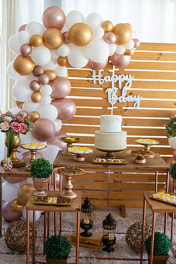 baby shower, white layered cake, variety of sweets, brown wooden table, balloons, dessert table, happy birthday, decorated baby shower, gold balloons, pink balloons, wooden backdrop
