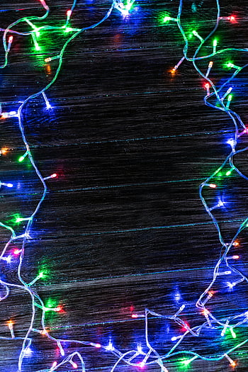 Christmas lights, vibrant lights, tangled lights, string lights, dark wood, festive designs, colorful lights, holiday lights, Christmas decorations, festive background, Christmas string lights
