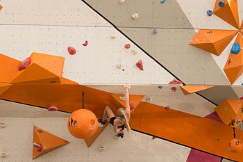 woman climbing, indoor climbing wall, vibrant climbing wall, athlete bouldering, indoor bouldering, climbing holds, indoor climbing gym, climbing sport, climbing wall, bouldering wall, indoor climbing