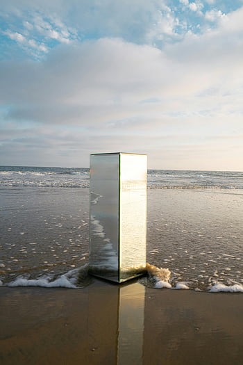 glass cabin, beach, vertical mirror, sea reflection, sky reflection, sunset, beach shore, soft sunset, mirror art, coastal art, reflective sculpture