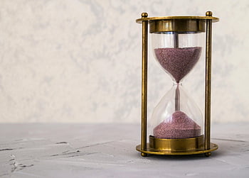 hourglass, golden frame, pink sand, time symbol, patience symbol, textured surface, traditional hourglass, clear hourglass, sand timer, time measurement, antique hourglass