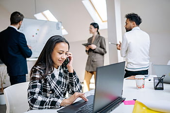 woman using laptop, work colleagues, modern office, business professionals, collaborating, laptops, discussions, office environment, professional setting, workplace interaction, team collaboration